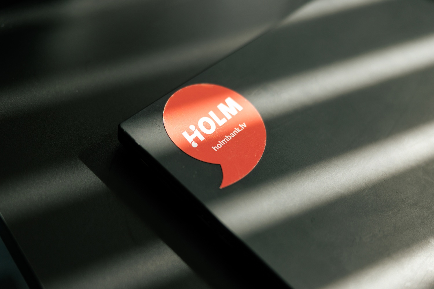 Holm Bank logo on a laptop cover